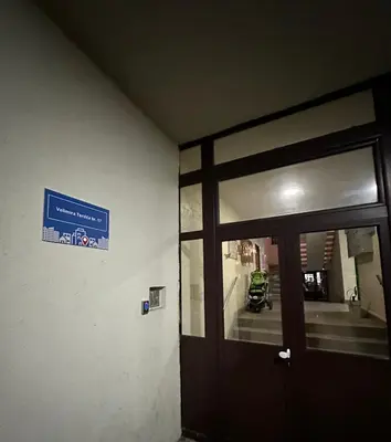 a door to a building with a sign on it at Podgorica Great location in Podgorica
