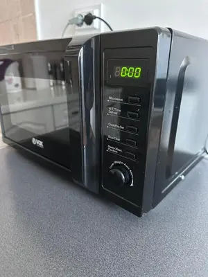 a microwave oven sitting on top of a counter at Podgorica Great location in Podgorica