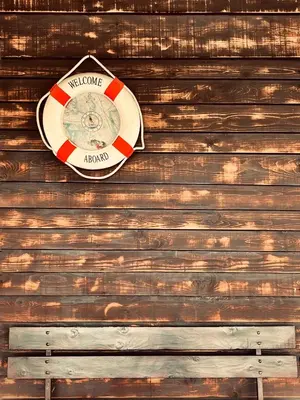 a sign on the side of a wooden wall at Kućica Vjera Ada Bojana in Ulcinj