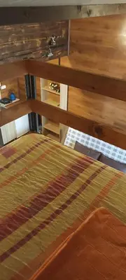 a bed in a room with wooden walls and a bedutenewayangering at Kućica Vjera Ada Bojana in Ulcinj