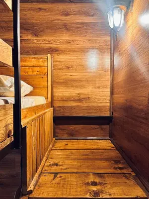 a wooden cabin with a bunk bed and a lamp at Kućica Vjera Ada Bojana in Ulcinj