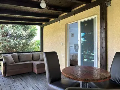 a patio with a table and chairs and a couch at Christopher's apartments in Ulcinj