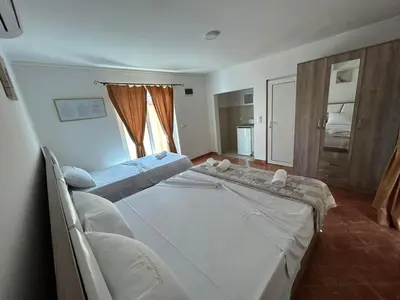 a bedroom with two beds and a window at Christopher's apartments in Ulcinj