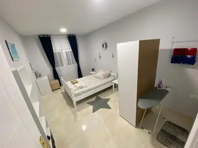 a small room with a bed and a chair at Kotor Apartman Green Sailor in Kotor