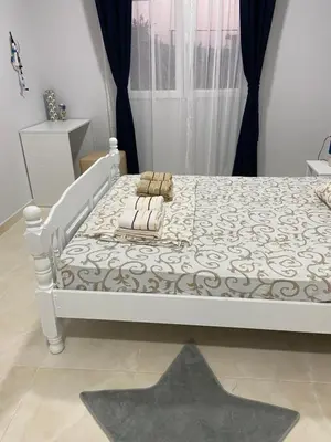 a white bed with two pillows on it in a room at Kotor Apartman Green Sailor in Kotor