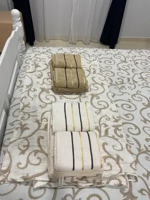 a room with a bed with towels on the floor at Kotor Apartman Green Sailor in Kotor