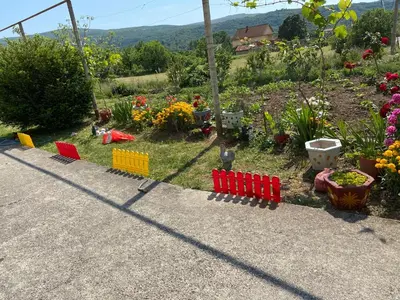 a toy train on the side of a garden at Kotor Apartman Green Sailor in Kotor