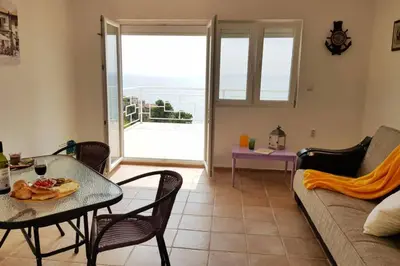 a living room with a couch and a table at Apartman Aleksandra in Ulcinj