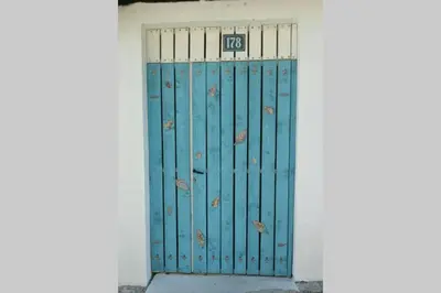 a blue door with a sign on it at Apartman Aleksandra in Ulcinj