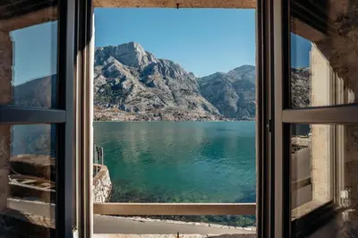 a window with a view of a mountain at 18th Century Villa in the UNESCO Bay of Kotor in Kotor