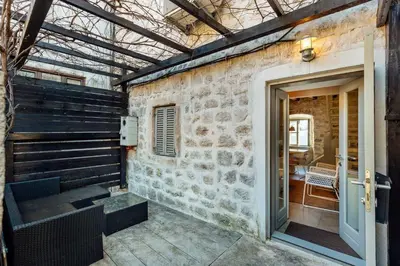 a room with a stone wall and a doorway at 18th Century Villa in the UNESCO Bay of Kotor in Kotor