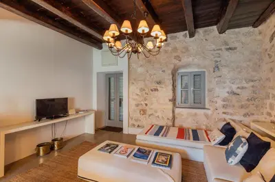 a living room with a couch and a chandelier at 18th Century Villa in the UNESCO Bay of Kotor in Kotor