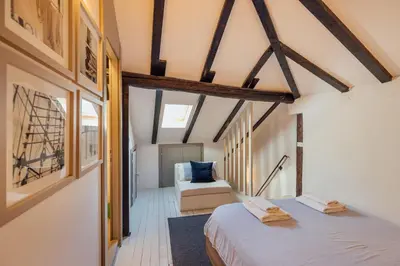 a bedroom with a bed and a couch in a room at 18th Century Villa in the UNESCO Bay of Kotor in Kotor