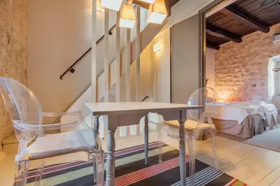a dining room with a table and two chairs at 18th Century Villa in the UNESCO Bay of Kotor in Kotor