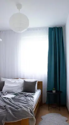 a bedroom with a bed and a large window at Laurel Apartments in Bar