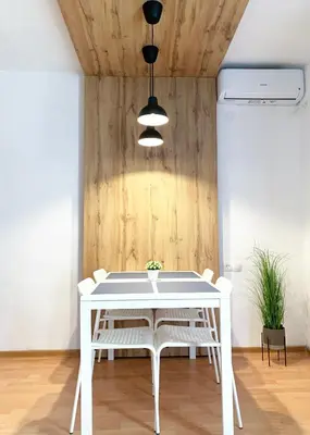 a dining room with a white table and white chairs at Laurel Apartments in Bar