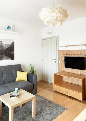 a living room with a couch and a table at Laurel Apartments in Bar