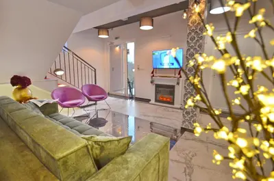 a living room with a couch and a fireplace at Residence Spa Apartments DUB in Kotor