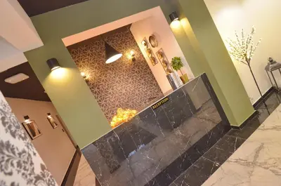 a lobby with a marble counter and a fireplace at Residence Spa Apartments DUB in Kotor