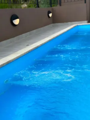 a large blue swimming pool with blue water at Residence Spa Apartments DUB in Kotor