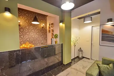 a lobby with green walls and a black counter at Residence Spa Apartments DUB in Kotor