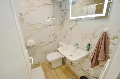 a bathroom with a toilet and a sink at Residence Spa Apartments DUB in Kotor