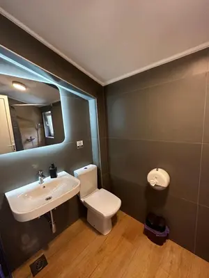a bathroom with a sink and a toilet and a mirror at Residence Spa Apartments DUB in Kotor
