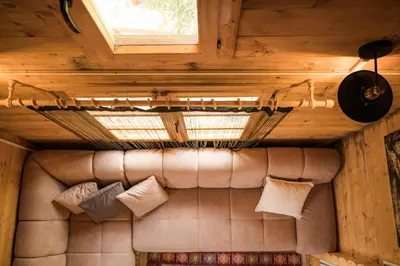 a couch in a room with a ceiling and a window at Madre Natura Glamping in Ulcinj