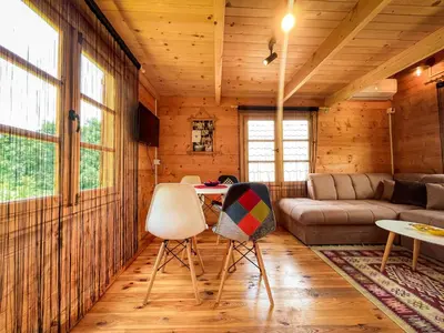 a living room with a couch and a table and chairs at Madre Natura Glamping in Ulcinj