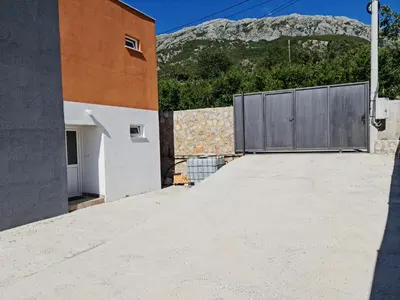 a view from the roof of a house with a gate at Apartman Nikocevic 2 in Bar