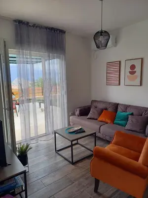 a living room with a couch and a table at Apartman Nikocevic 2 in Bar