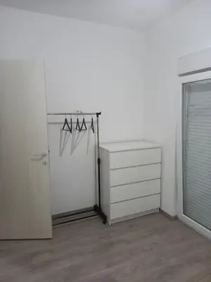 a white room with a refrigerator and a dresser at Apartman Nikocevic 2 in Bar