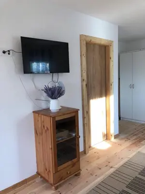 a living room with a flat screen tv on a wall at Rajana Bungalow - Ulcinj in Ulcinj