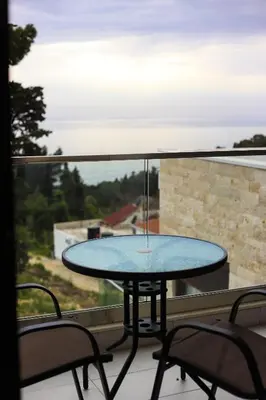a table on a balcony with a view of the ocean at Arte Luxury Pool Apartmets in Ulcinj