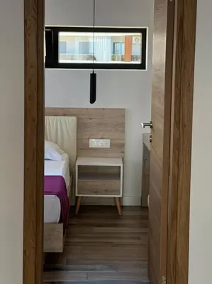 a small bedroom with a bed and a window at Maghrib Hotel in Ulcinj