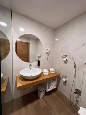a bathroom with a sink and a shower at Maghrib Hotel in Ulcinj