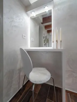 a white chair in a room with a mirror at Luxury Boutique Studio in Budva