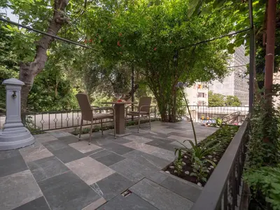 a patio with chairs and a table and trees at Luxury Boutique Studio in Budva