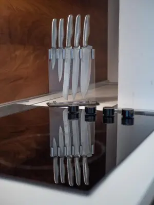 a group of knives hanging on a knife block at Apartments Garden Azure Budva in Budva