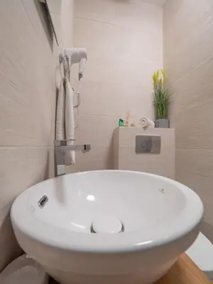 a bathroom with a white sink and a toilet at Apartments Garden Azure Budva in Budva