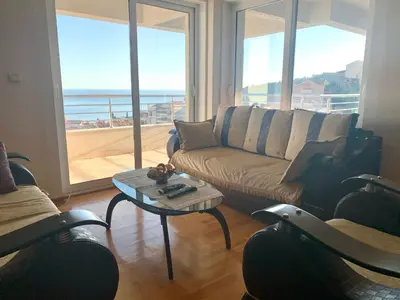 a living room with a couch and a table at Blue Sky Apartment in Petrovac na Moru