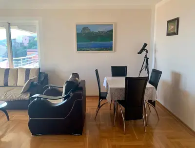 a living room with a table and chairs at Blue Sky Apartment in Petrovac na Moru