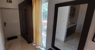 a mirror in a room with a bathroom at Apartments Danilo Kažanegra in Sveti Stefan