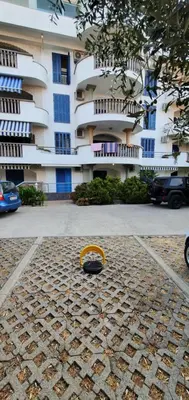 a yellow object sitting on the ground in front of a building at Apartman Azzuro in Pržno