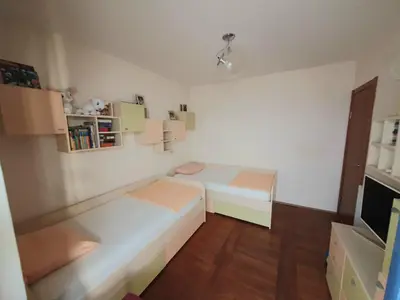 a small room with two beds in it at Apartman Azzuro in Pržno