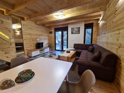 a living room with a couch and a table at OLEA COTTAGE in Ulcinj