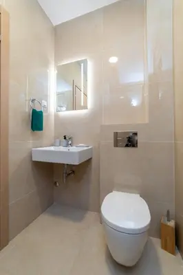 a bathroom with a white toilet and a sink at Ana`s apartment Budva MNE in Budva
