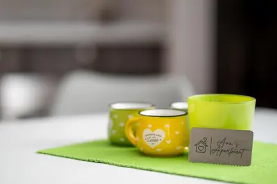 two yellow cups sitting on a green napkin at Ana`s apartment Budva MNE in Budva