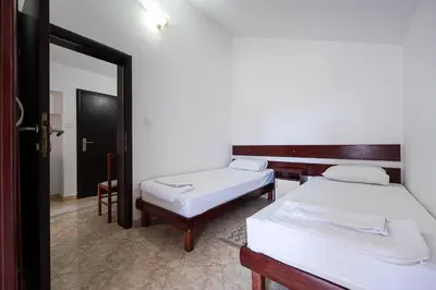 a room with two beds and a mirror at Garni Hotel S Coast in Budva