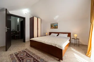 a bedroom with a large bed in a room at Garni Hotel S Coast in Budva